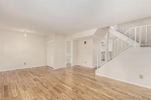 a view of an empty room with wooden floor