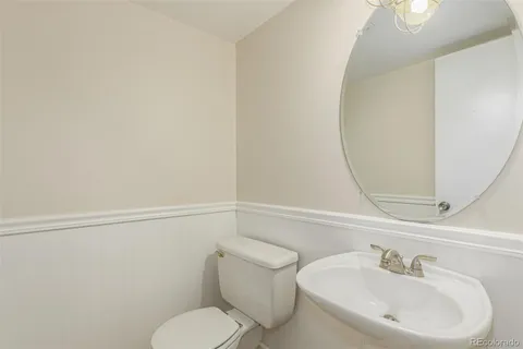 a white toilet sitting next to a bathroom sink