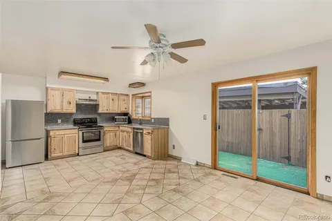 a kitchen with stainless steel appliances a refrigerator and a stove top oven
