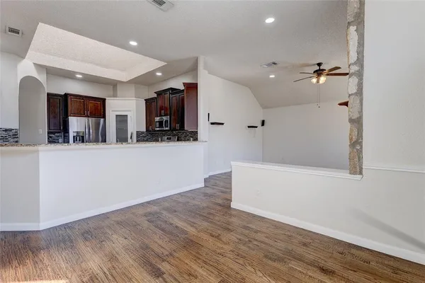 a view of a kitchen with wooden floor and a sink