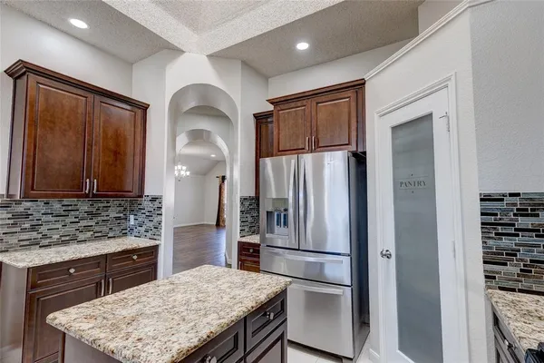 a kitchen with a refrigerator and a sink