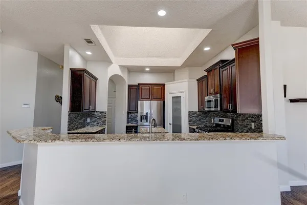 a view of large kitchen with stainless steel appliances