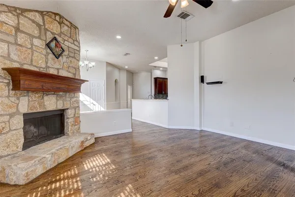 a view of a kitchen and an empty room