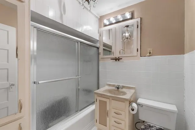 a bathroom with a shower a toilet and sink
