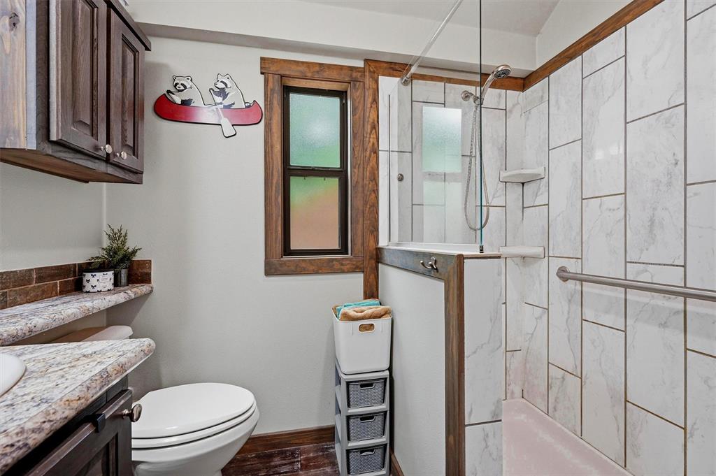 3958 Ranch Road Whitesboro, TX 76273 - Photo 18 of 40 Bathroom featuring a walk-in shower with white tiled walls and glass enclosure