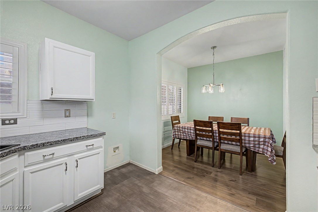 2153 Quarry Ridge Street, Unit 103 Las Vegas, NV 89117 - Photo 19 of 42 A well-lit kitchen with granite countertops seamlessly transitions into an inviting dining area.