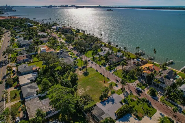 an aerial view of a houses with a lake view
