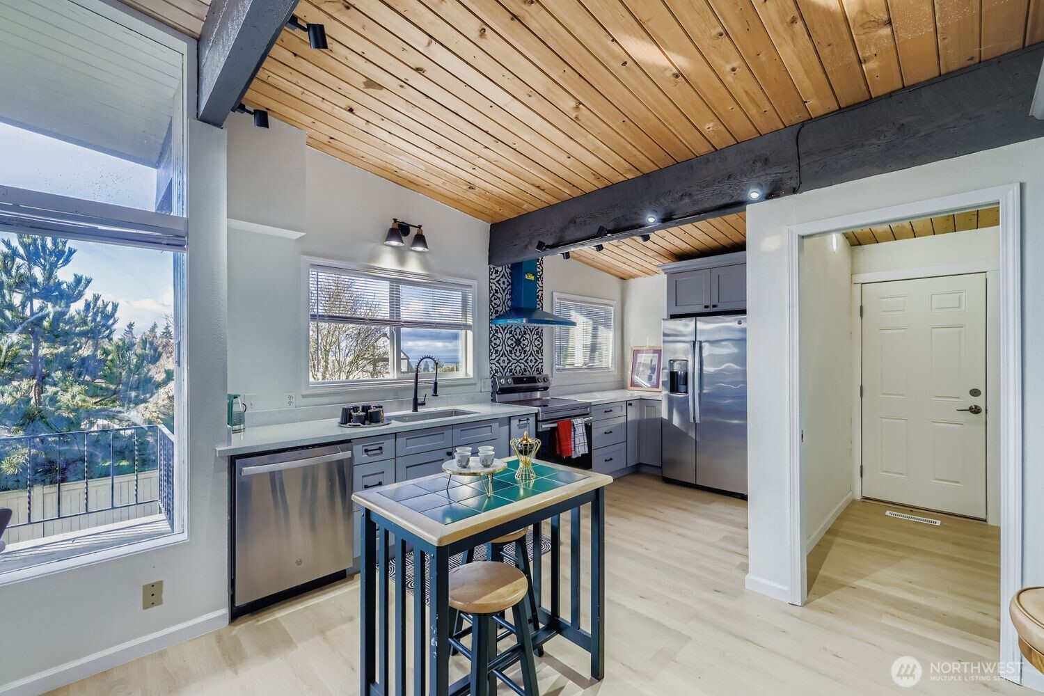 17926 73rd Avenue West Edmonds, WA 98026 - Photo 7 of 40 a kitchen with stainless steel appliances granite countertop a table chairs and a refrigerator