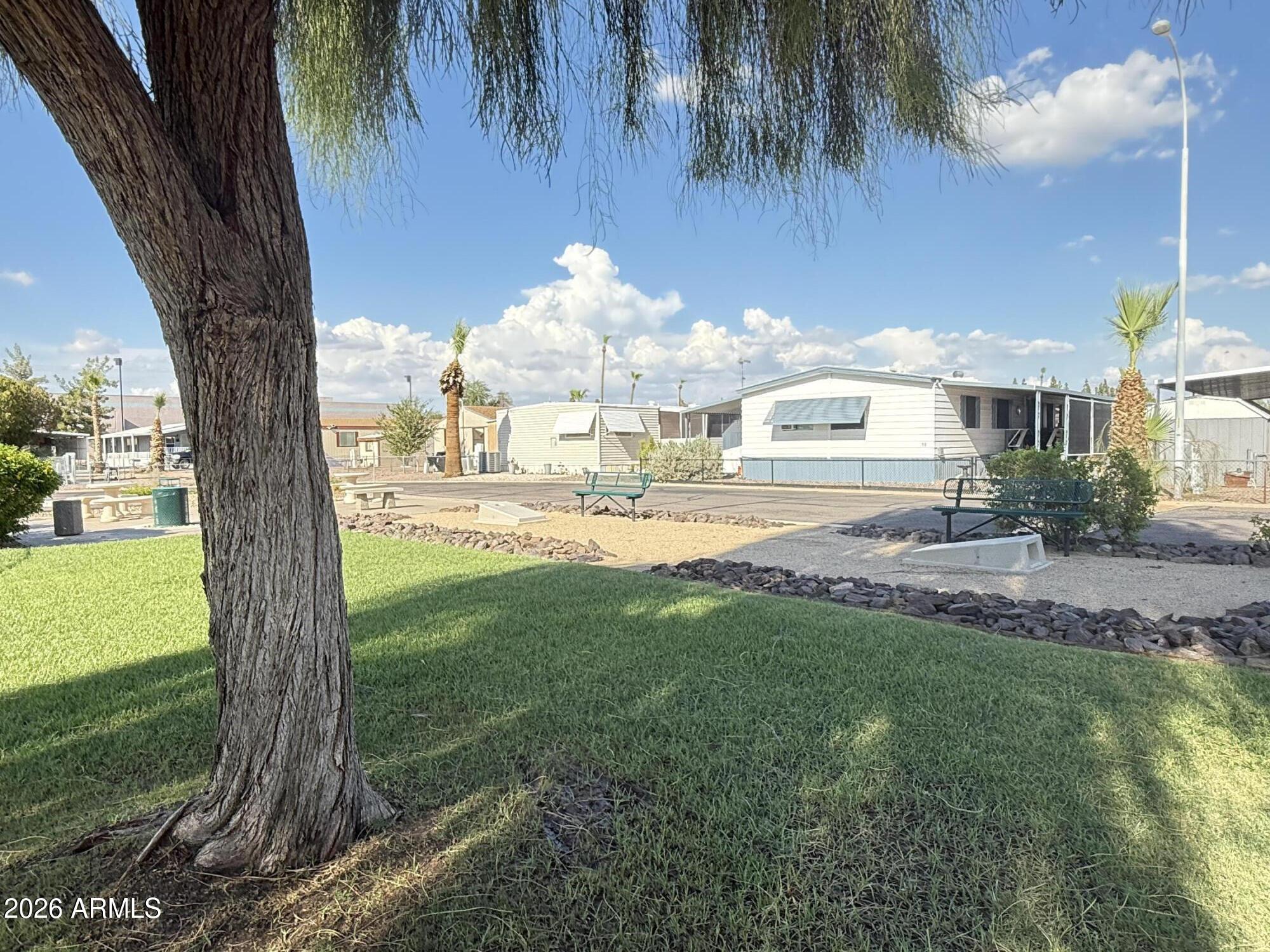 535 South Alma School Road, Unit 113 Mesa, AZ 85210 - Photo 40 of 41 a backyard of a house with table and chairs