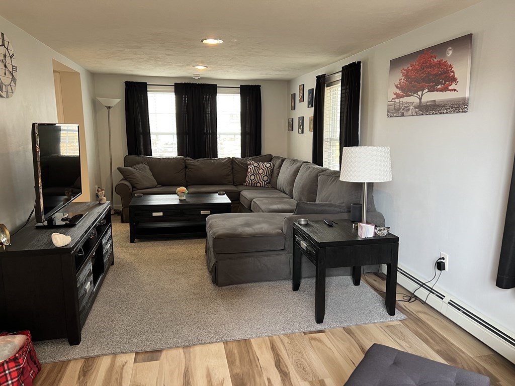 34 Colonial Road Webster, MA 01570 - Photo 14 of 35 a living room with furniture and a flat screen tv
