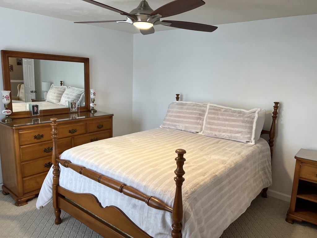 34 Colonial Road Webster, MA 01570 - Photo 23 of 35 a bedroom with a bed and a chandelier