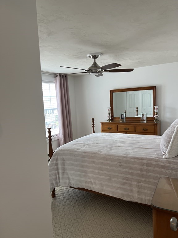 34 Colonial Road Webster, MA 01570 - Photo 25 of 35 a bedroom with a bed and a chandelier