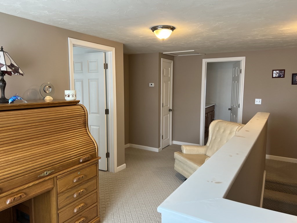 34 Colonial Road Webster, MA 01570 - Photo 32 of 35 a view of a hallway with furniture and stairs