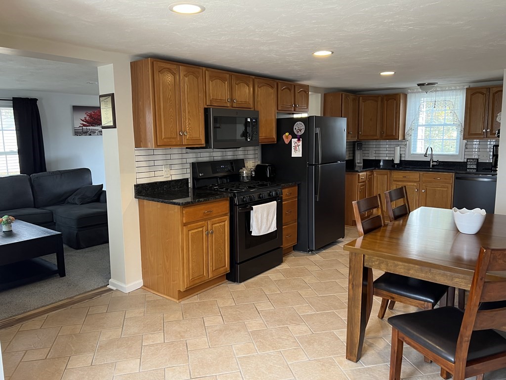 34 Colonial Road Webster, MA 01570 - Photo 4 of 35 a kitchen with stainless steel appliances granite countertop a stove refrigerator and microwave