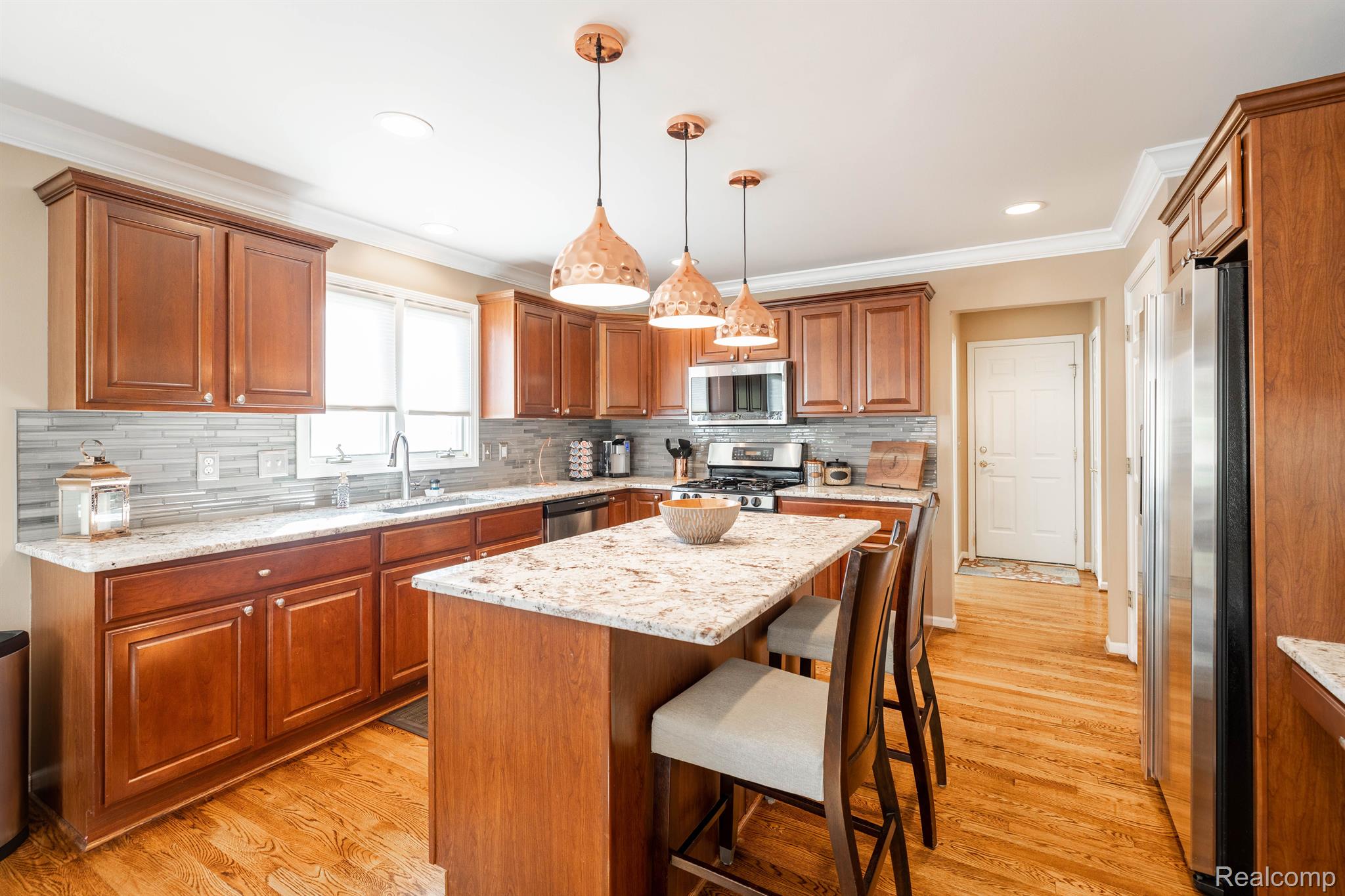 8464 Lake Road Grosse Ile, MI 48138 - Photo 15 of 44 kitchen with center work island has counter seatin