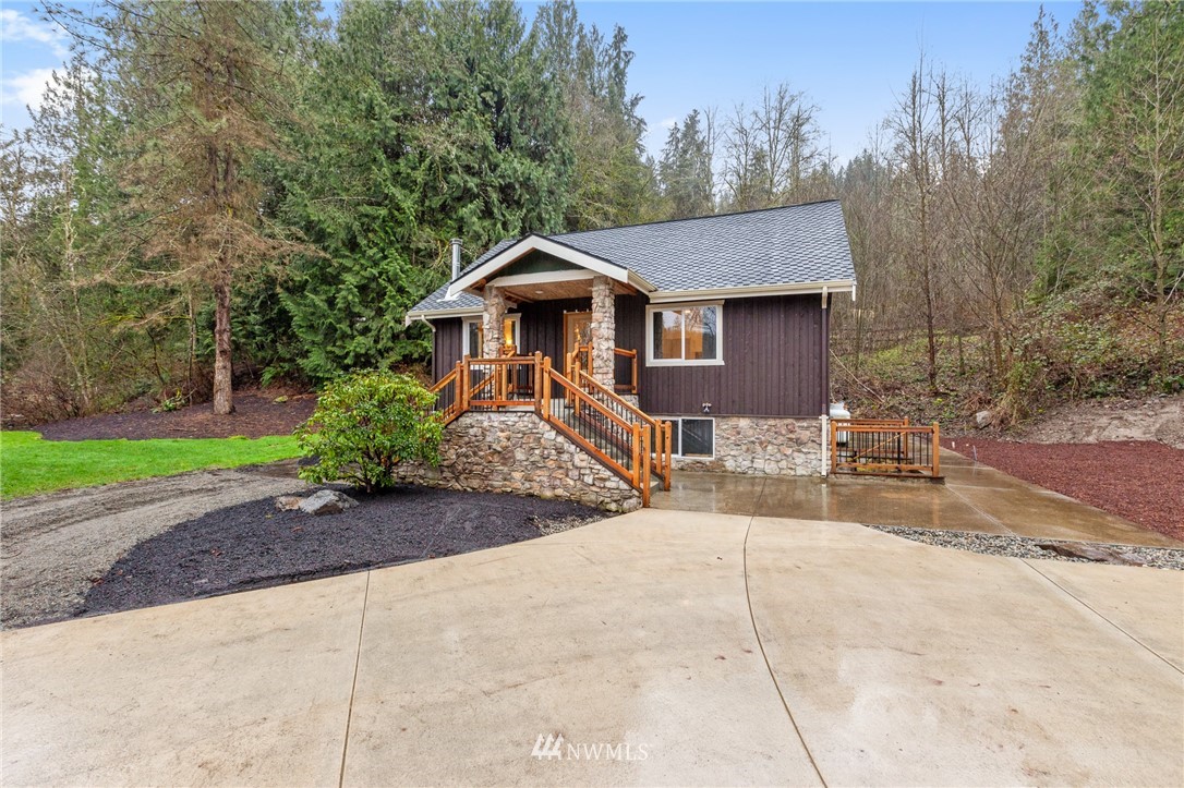 18645 Renton-Maple Valley Road Maple Valley, WA 98038 - Photo 1 of 30 a front view of a house with a garden