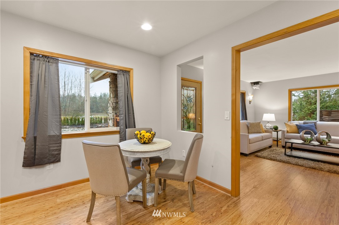 18645 Renton-Maple Valley Road Maple Valley, WA 98038 - Photo 9 of 30 a view of a dining room with furniture window and wooden floor