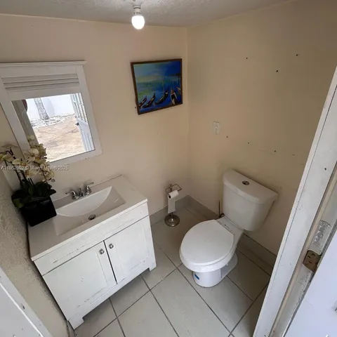 a white toilet sitting next to a bathroom sink
