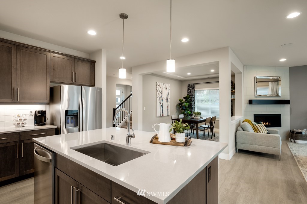 3602 200th Place Southeast, Unit KF15 Bothell, WA 98012 - Photo 14 of 34 a kitchen with a sink a counter and chairs