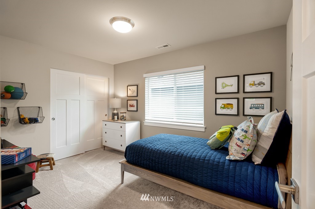 3602 200th Place Southeast, Unit KF15 Bothell, WA 98012 - Photo 21 of 34 a bedroom with a bed and a couch