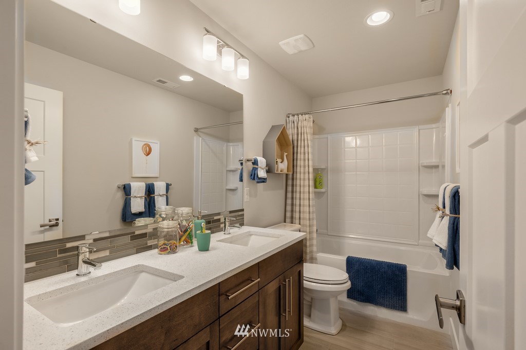 3602 200th Place Southeast, Unit KF15 Bothell, WA 98012 - Photo 22 of 34 a bathroom with a double vanity sink toilet and shower