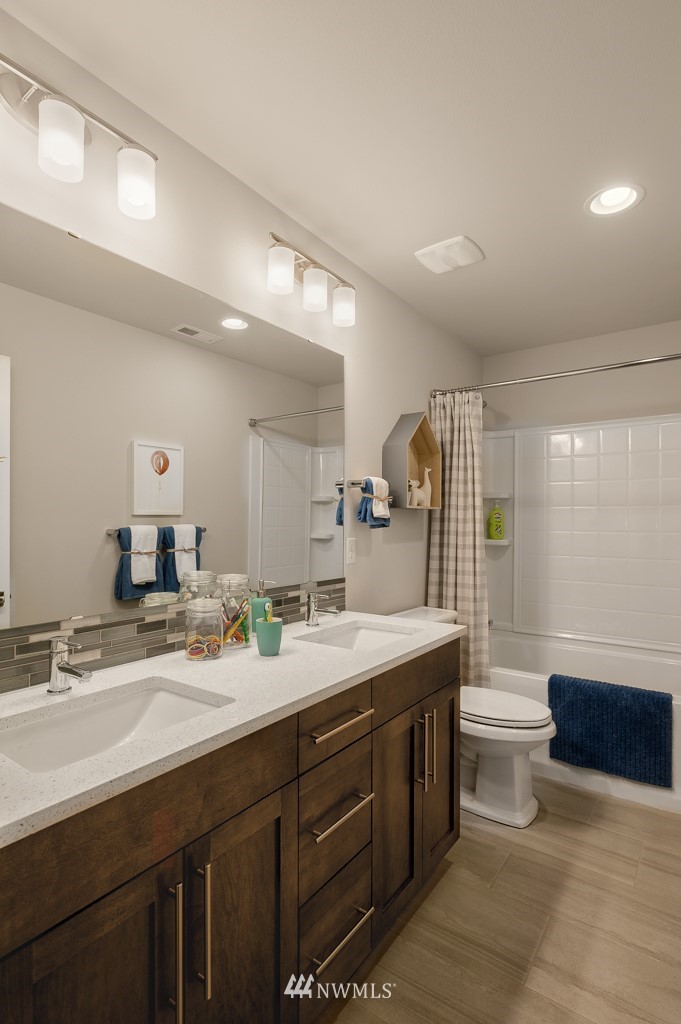 3602 200th Place Southeast, Unit KF15 Bothell, WA 98012 - Photo 23 of 34 a bathroom with a sink double vanity granite and a mirror