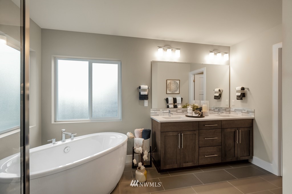3602 200th Place Southeast, Unit KF15 Bothell, WA 98012 - Photo 29 of 34 a bathroom with a bathtub a double vanity sink and mirror