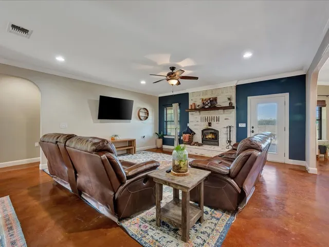 a living room with furniture fireplace and a flat screen tv