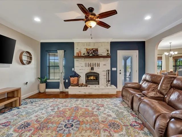 a living room with furniture a window and a fireplace