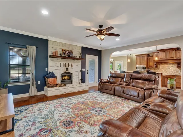 a living room with furniture a fireplace and a rug