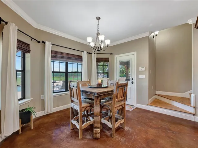 a view of a dining room with furniture window and outside view