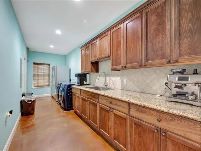 a kitchen with stainless steel appliances granite countertop a sink stove and cabinets