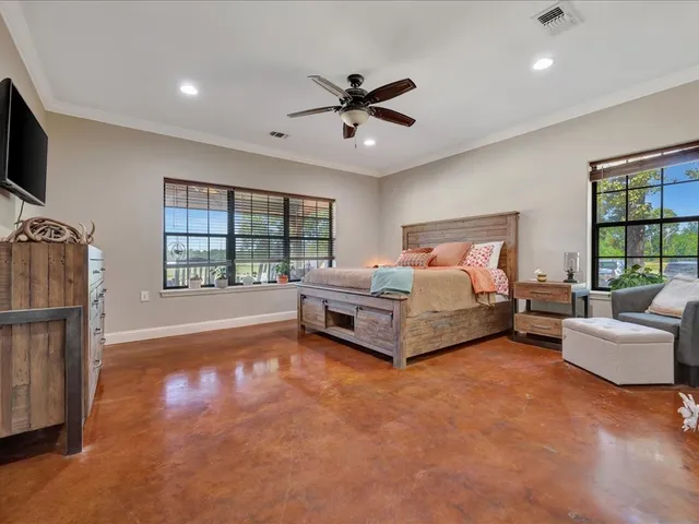 a bedroom with furniture and a large window