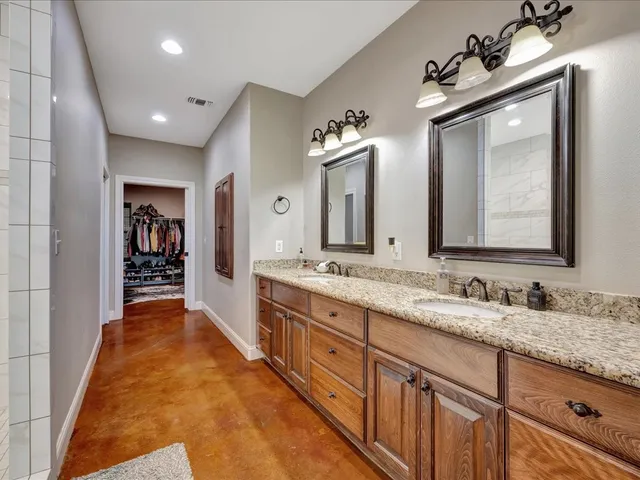 a spacious bathroom with a double vanity sink and a mirror