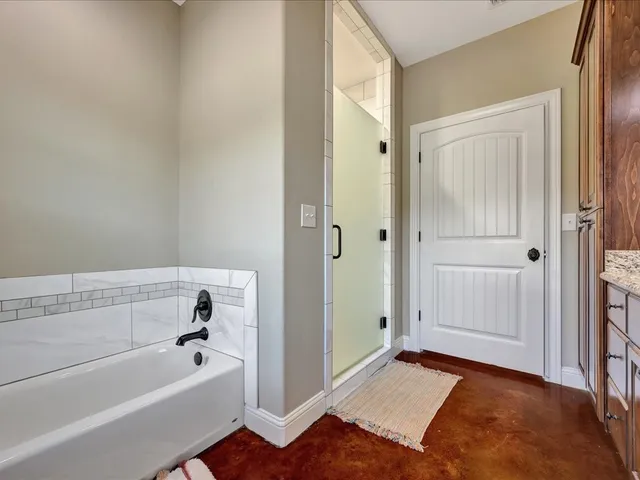 a bathroom with a bathtub and a shower