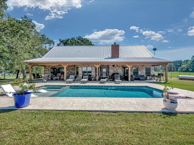 a view of patio with a table and chairs under an umbrella