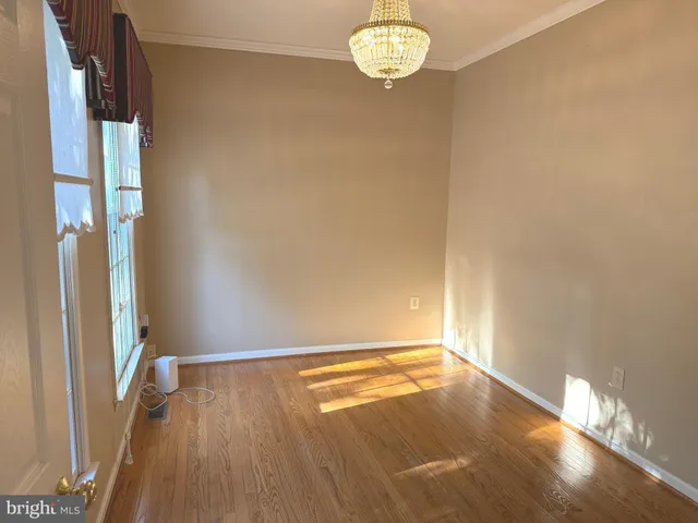 a view of a livingroom with a ceiling fan and window