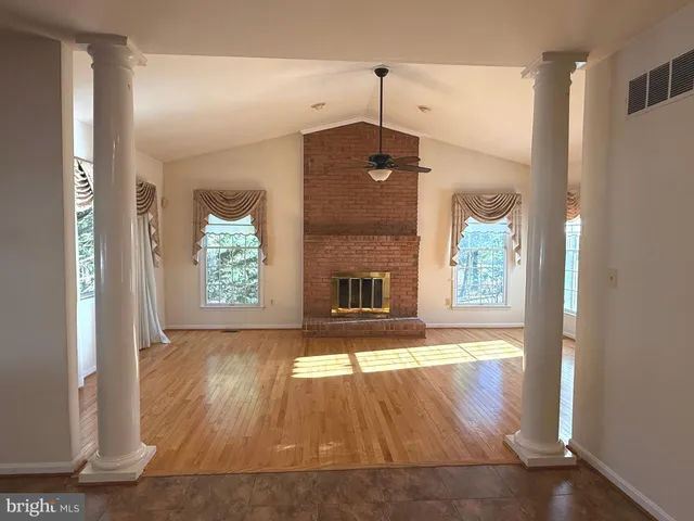 a balcony with wooden floor table and chairs
