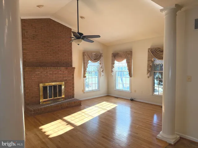 a kitchen with stainless steel appliances granite countertop a sink a stove counter space and wooden floor