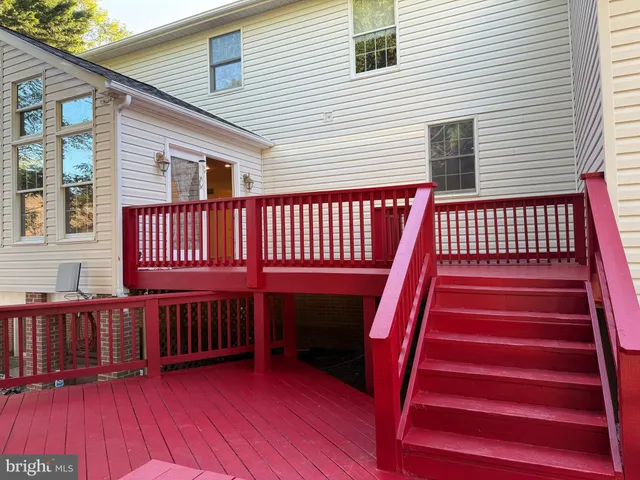 a kitchen with stainless steel appliances granite countertop a refrigerator a stove and a sink with wooden floors