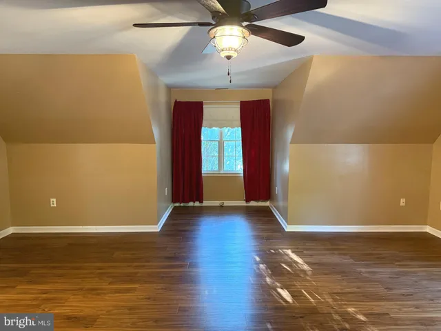 a bathroom with a granite countertop toilet sink and a mirror