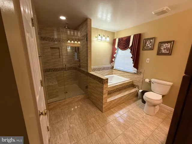 a room with wooden floor and pool table