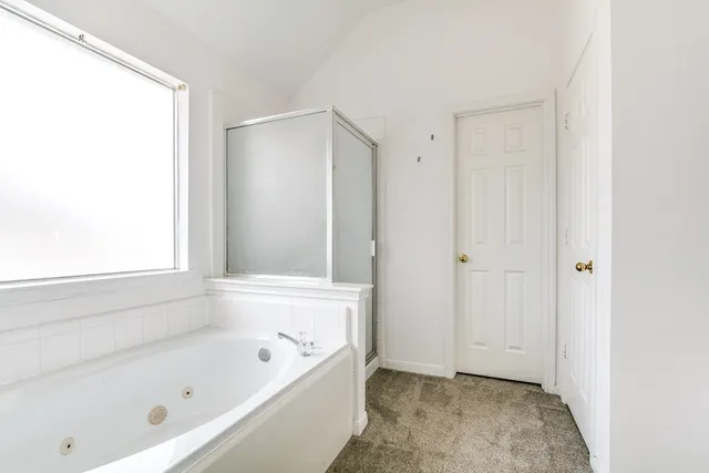 a bedroom with a large bed and a flat screen tv