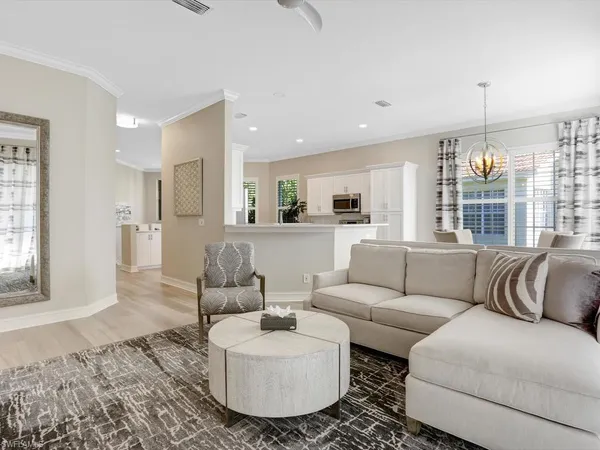 a living room with furniture and kitchen view