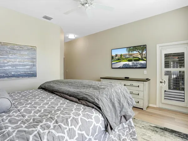 a bedroom with a bed and a painting on the wall