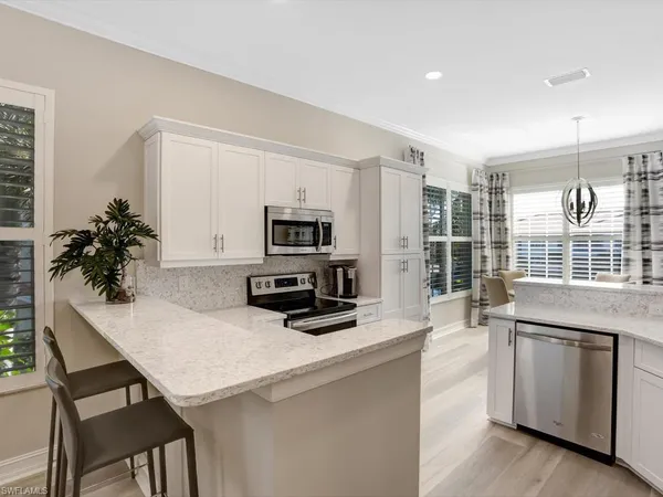 a kitchen with a stove a sink and a refrigerator