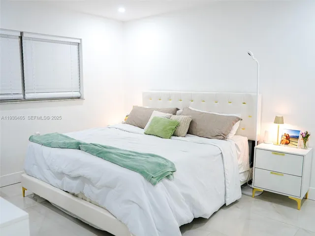 a living room with kitchen island furniture and a flat screen tv
