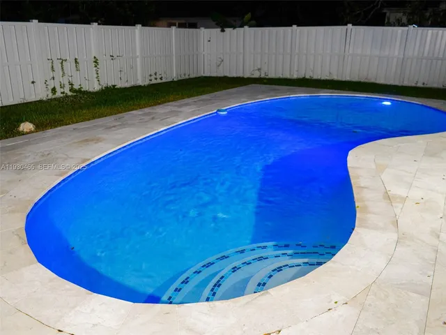 a bathroom with a sink a faucet a potted plant and a mirror