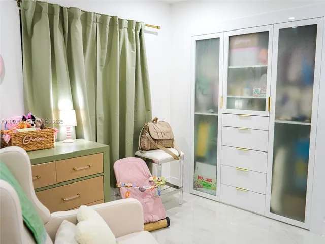 a living room with kitchen island furniture and a kitchen view