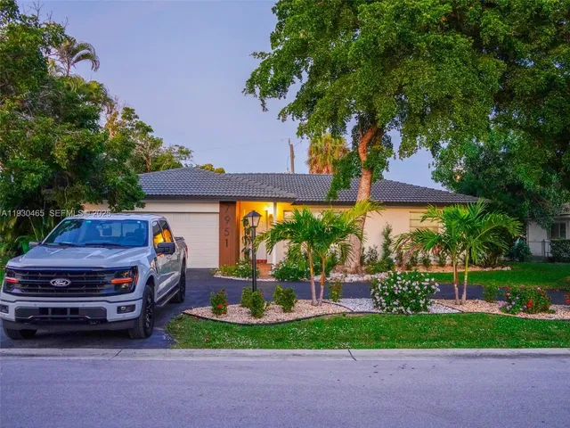 a view of a backyard with plants and a garden